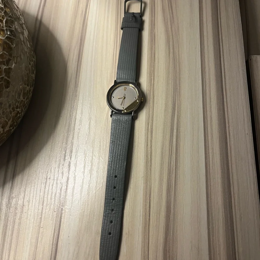Gucci branded watch with grey leather strap and gold details